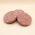 Rosetta Red Vegan Burger, three frozen patties on a warm cream background